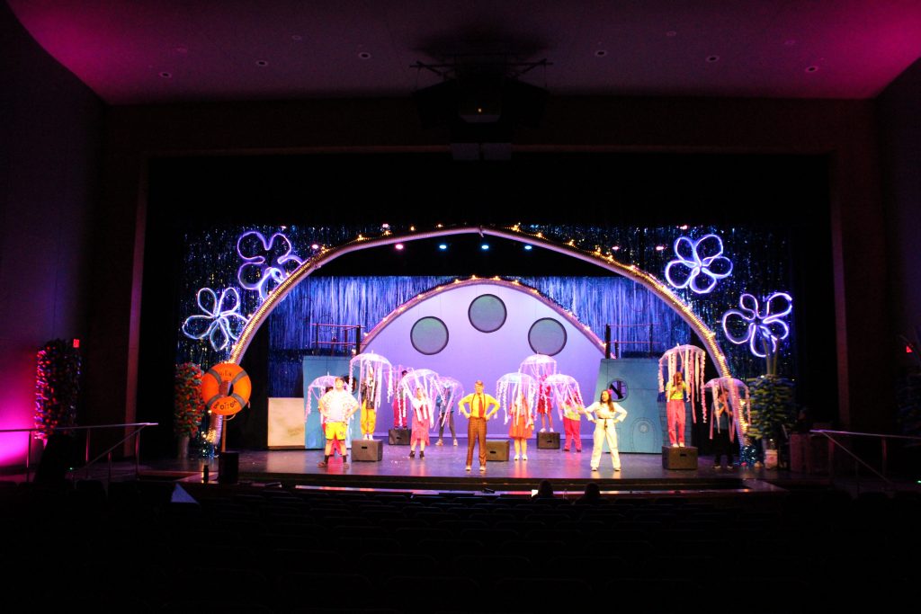 A large stage that looks like Bikini Bottom. The stage is flooded with jellyfish umbrellas. SpongeBob, Patrick, and Sandy all stand in hero position.