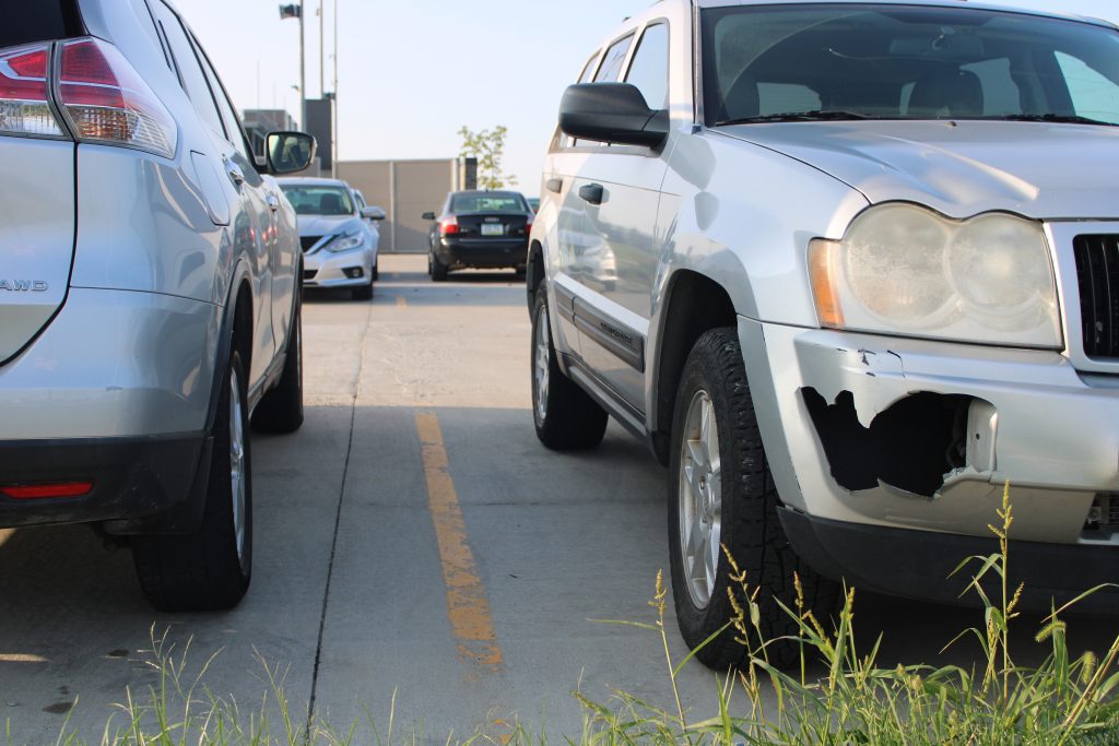 A car with a chunk missing from the bumper