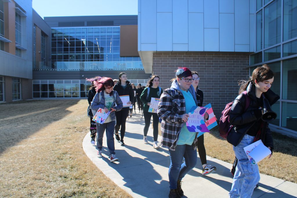 students walk on path outside of Waukee Northwest high school
